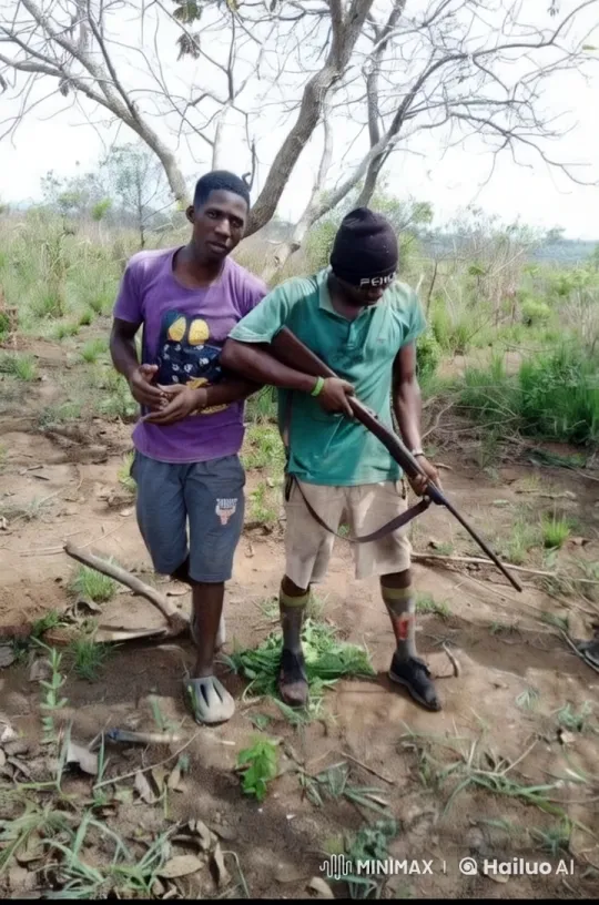 Two Men in Open Field with One Holding Rifle – AI Generated Video | Hailuo AI