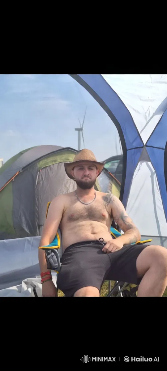 Relaxed Cowboy Enjoying Campsite with Wind Turbine – AI Generated Video | Hailuo AI