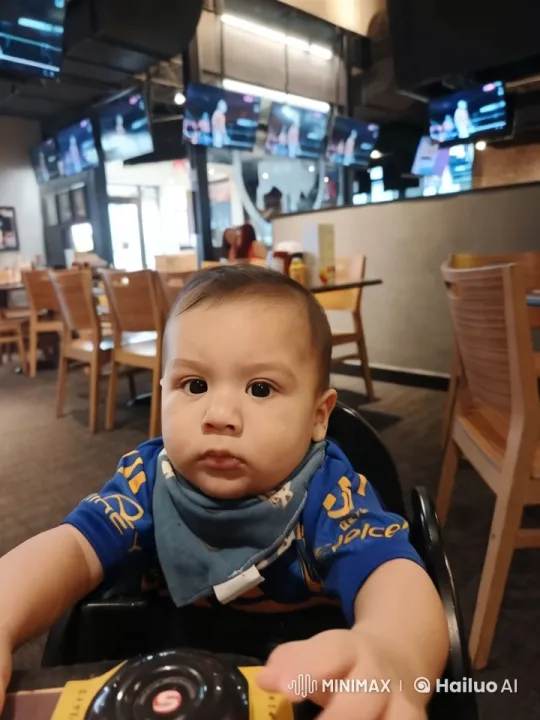 Baby in High Chair at Modern Sports-Themed Restaurant – AI Generated Video | Hailuo AI
