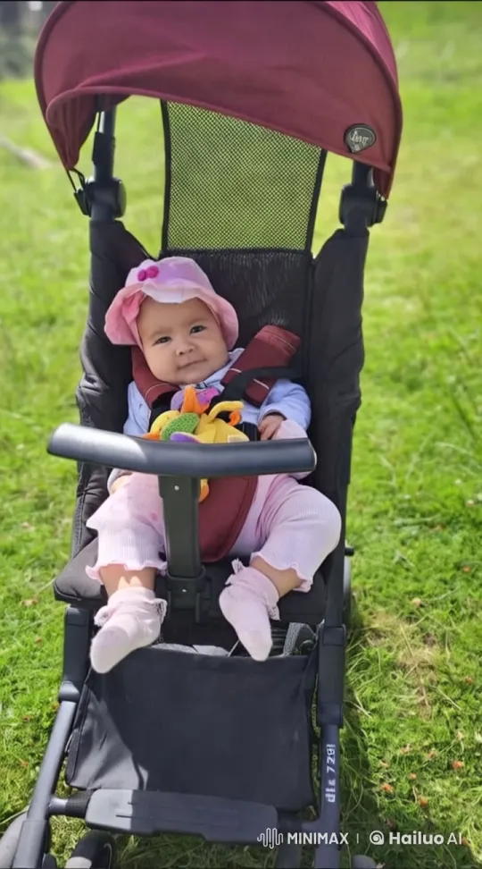 Baby Dancing Joyfully in Stroller on Lush Lawn – AI Generated Video | Hailuo AI