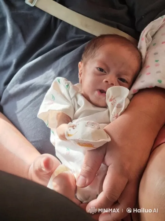 Intimate Portrait of Newborn and Adult's Tender Moment – AI Generated Video | Hailuo AI