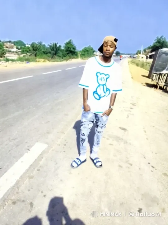 Young Man in Teddy Bear Shirt Amidst Serene Countryside – AI Generated Video | Hailuo AI