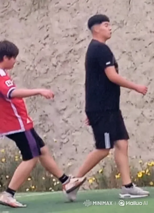 Boys Share Intimate Moment in Serene Grassland Video – AI Generated Video | Hailuo AI