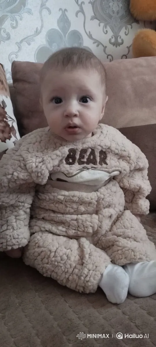 Cozy Baby in Fluffy Outfit on Couch – AI Generated Video | Hailuo AI