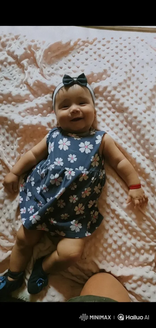Baby in Blue Dress on Textured Blanket – AI Generated Video | Hailuo AI