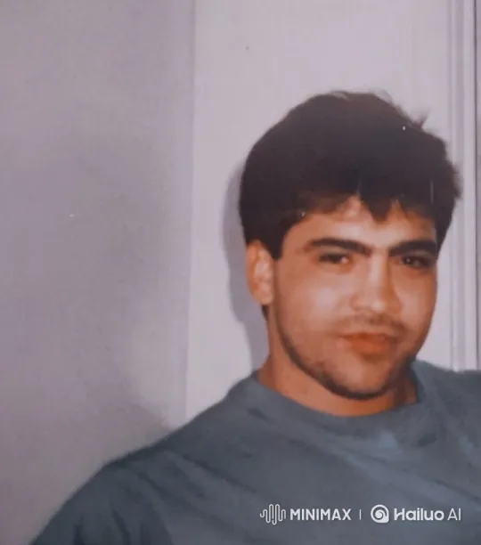 Young Man in Blue Shirt with Gentle Smile – AI Generated Video | Hailuo AI