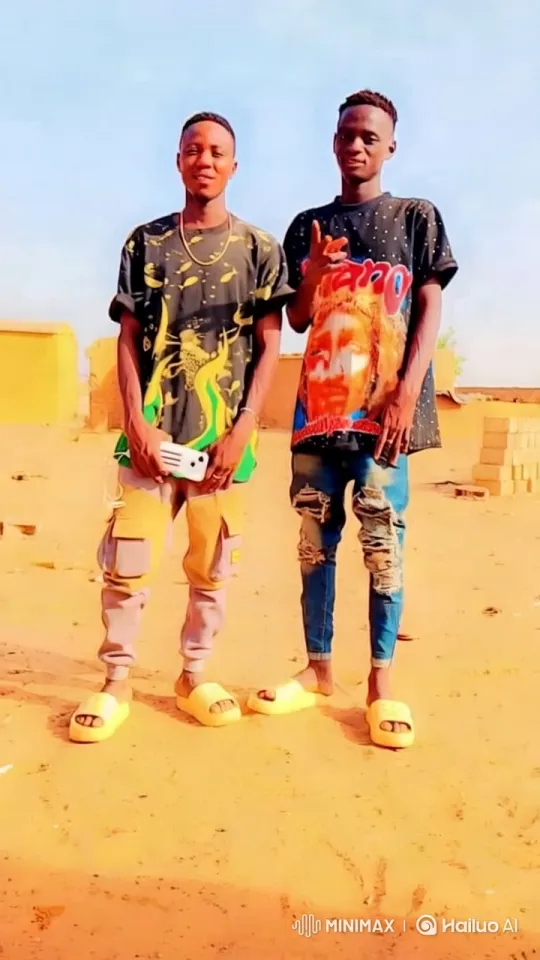 Two Men in Casual Attire in a Sandy Outdoor Setting – AI Generated Video | Hailuo AI