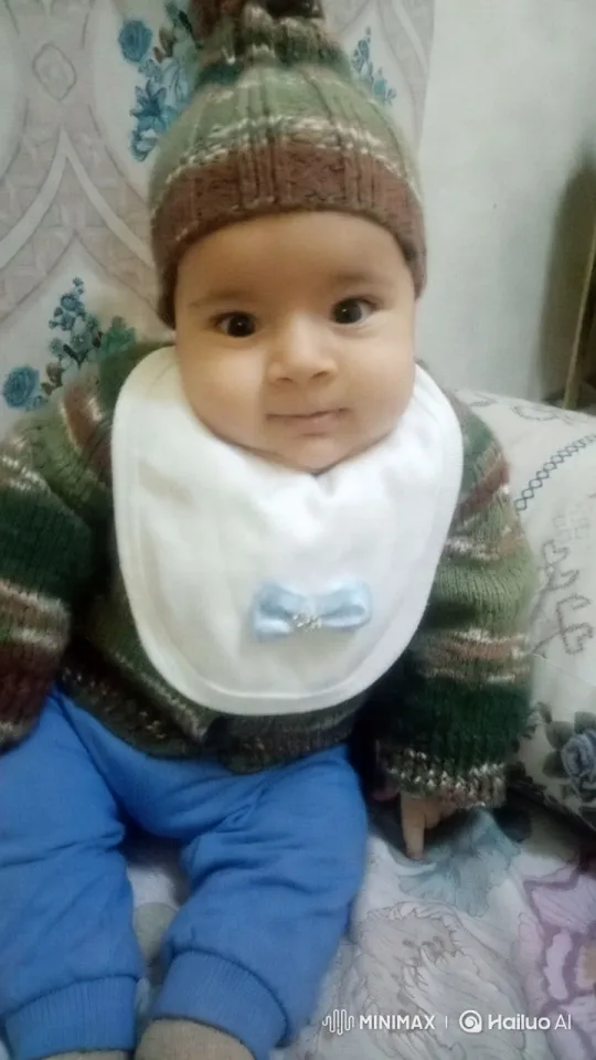 Baby Dancing Joyfully in Cozy Outfit on Patterned Bedspread – AI Generated Video | Hailuo AI
