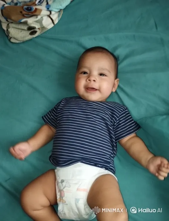 Baby Dancing Joyfully on Teal Bed – AI Generated Video | Hailuo AI