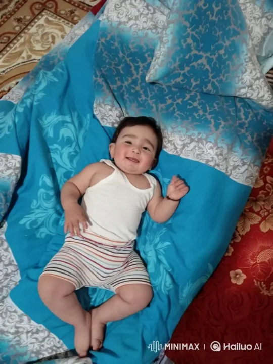 Seamless Loop of a Baby's Gentle Movements on a Colorful Bedspread – AI Generated Video | Hailuo AI