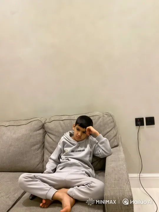 Young Boy Arrested on Couch in Minimalist Room – AI Generated Video | Hailuo AI
