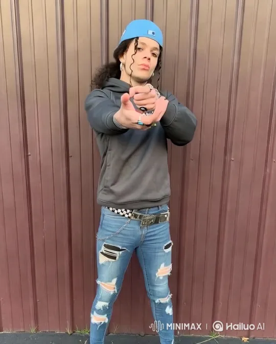 Young Man Mimics Joker with Pistol, Dramatic Pose – AI Generated Video | Hailuo AI