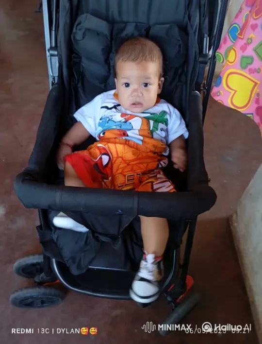 Child Joyfully Dancing in Stroller Against Colorful Backdrop – AI Generated Video | Hailuo AI