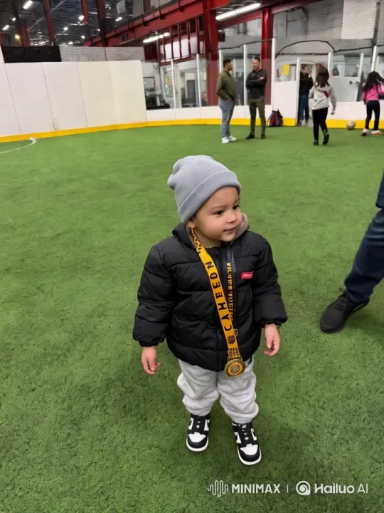 Child Showcases Medal in Indoor Soccer Setting – AI Generated Video | Hailuo AI