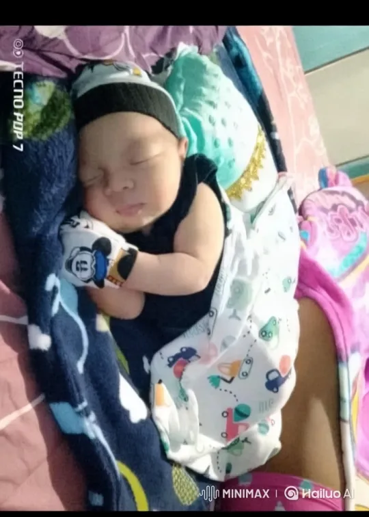 Baby's Serene Moment in Colorful Blanket Bed Setting – AI Generated Video | Hailuo AI