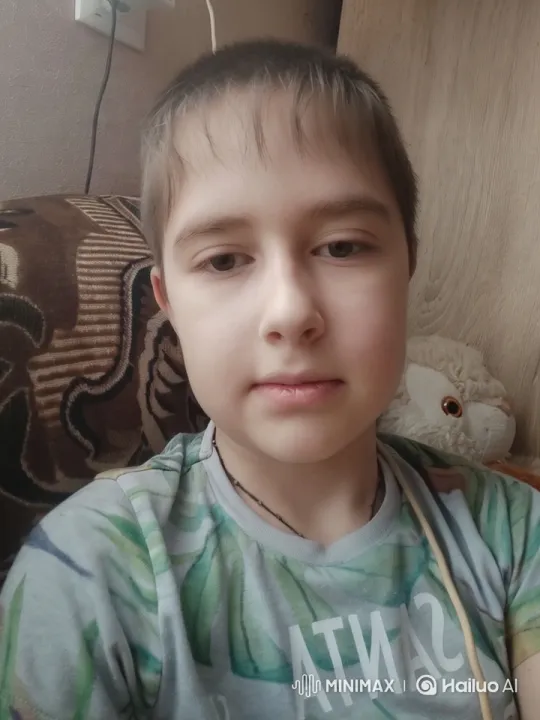Young Boy Engages with Camera in Cozy Home Setting – AI Generated Video | Hailuo AI