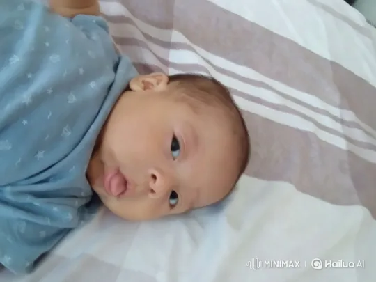 Peaceful Baby on Cozy Striped Bedspread – AI Generated Video | Hailuo AI