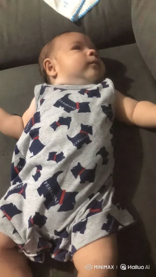 Baby in Cute Onesie on Gray Couch – AI Generated Video | Hailuo AI