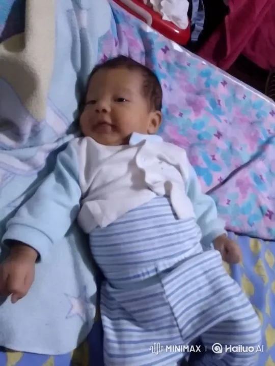 Baby Resting Peacefully on Patterned Blanket – AI Generated Video | Hailuo AI