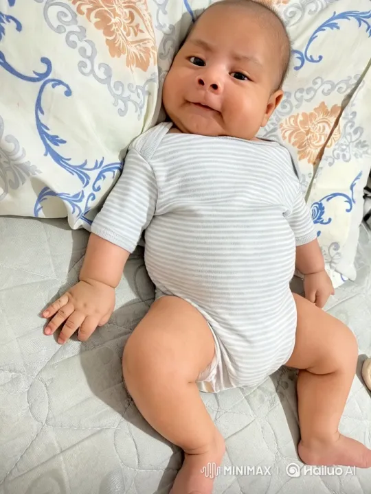 Baby Dancing in Striped Onesie on Patterned Bed – AI Generated Video | Hailuo AI