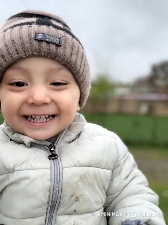 Joyful Child in Knitted Hat and Jacket Amidst Nature – AI Generated Video | Hailuo AI