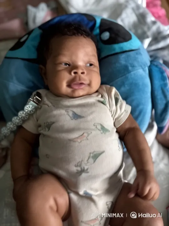 Baby in Dinosaur Onesie Playing with Plush Cushion – AI Generated Video | Hailuo AI