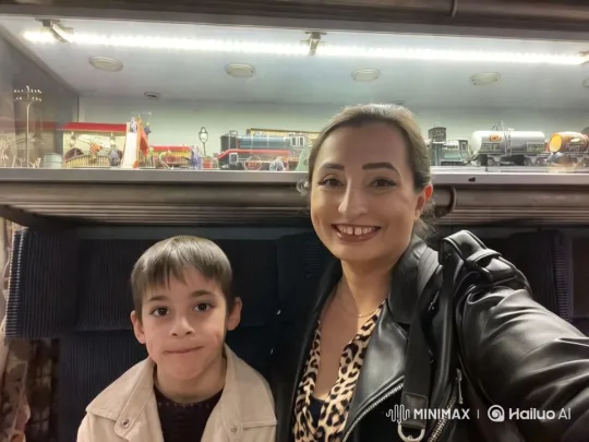Woman and Child Explore Detailed Model Train Display – AI Generated Video | Hailuo AI