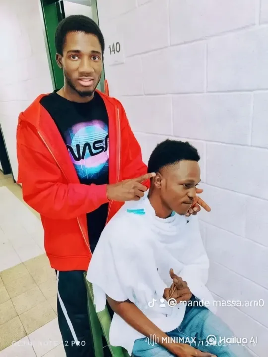 Young Man Giving Haircut in Hallway – AI Generated Video | Hailuo AI