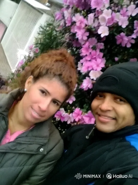 Romantic Couple's Kiss Amidst Pink Flowers – AI Generated Video | Hailuo AI