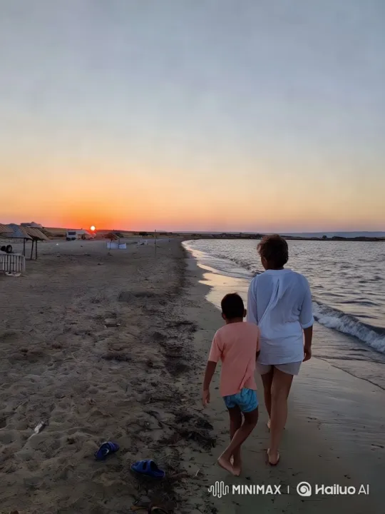 Sunset Stroll: Woman and Boy Enjoy Tranquil Beach Walk – AI Generated Video | Hailuo AI