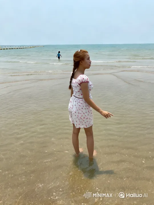 Young Woman in Floral Dress on Serene Beach – AI Generated Video | Hailuo AI