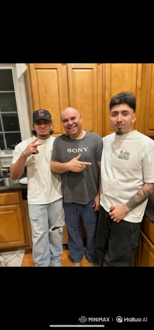 Three Men Share a Playful Group Hug in a Kitchen – AI Generated Video | Hailuo AI