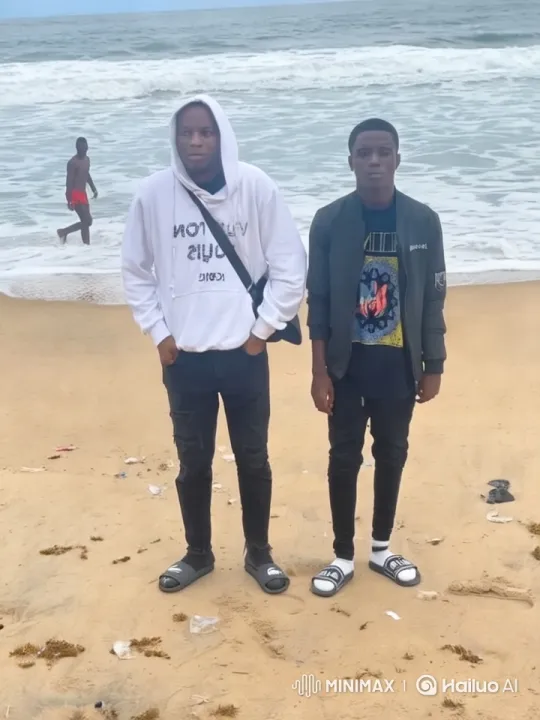 Beach Scene with Two Young Men and a Walking Person – AI Generated Video | Hailuo AI