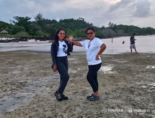 Women Pose Playfully on Muddy Beach with Scenic Background – AI Generated Video | Hailuo AI