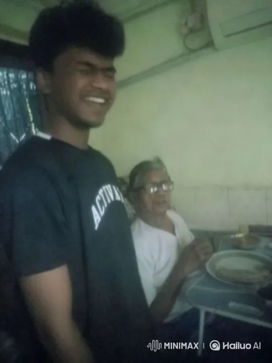 Young Man in Dim Room with Elderly Person Eating – AI Generated Video | Hailuo AI