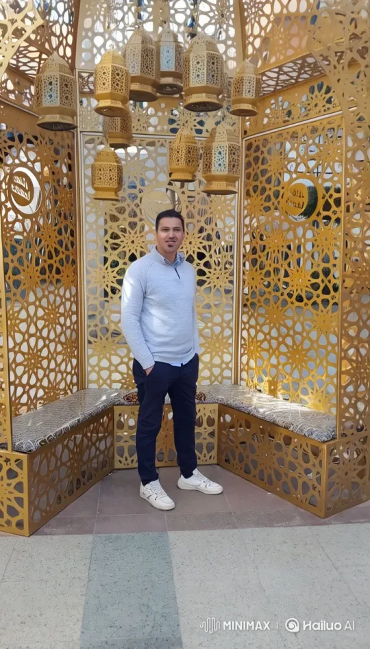 Eid Greetings from a Man in Front of a Golden Structure – AI Generated Video | Hailuo AI