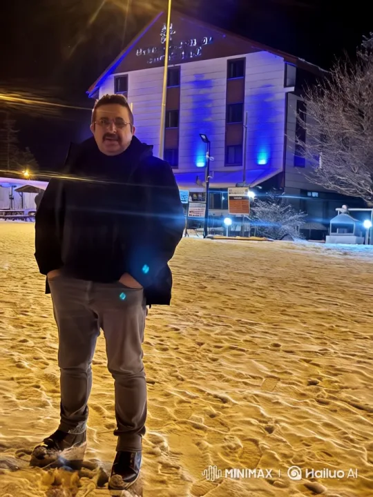 Night Scene: Person in Front of Lit Building – AI Generated Video | Hailuo AI