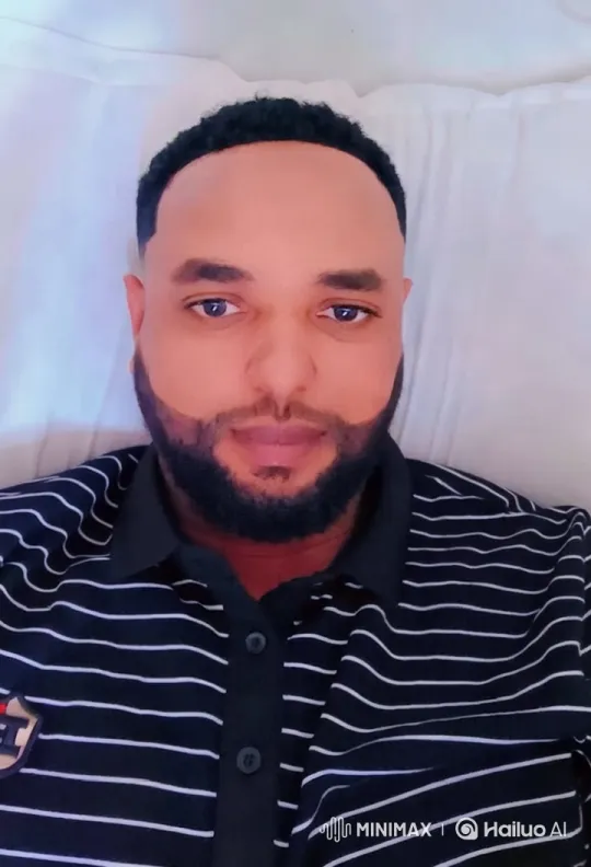 Man in Striped Shirt on Serene White Bed – AI Generated Video | Hailuo AI