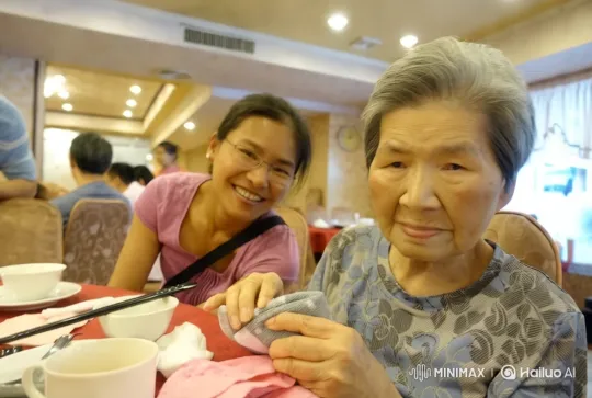 Grandmother and Granddaughter Share Tender Moment in Warm Restaurant – AI Generated Video | Hailuo AI