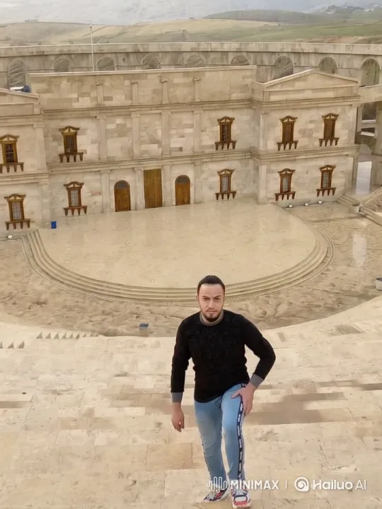 Man on Steps in Serene Landscape with Ancient Building – AI Generated Video | Hailuo AI