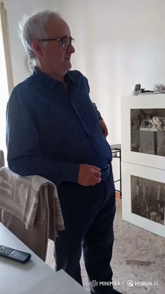 Man in Blue Shirt Observes Quietly in Sunlit Room – AI Generated Video | Hailuo AI