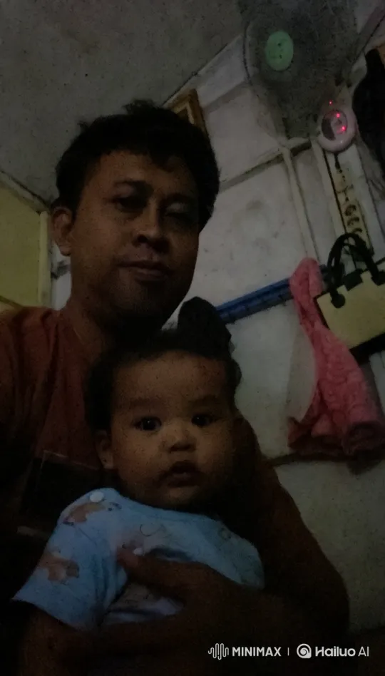 Intimate Moment: Man and Baby in Dim Light – AI Generated Video | Hailuo AI