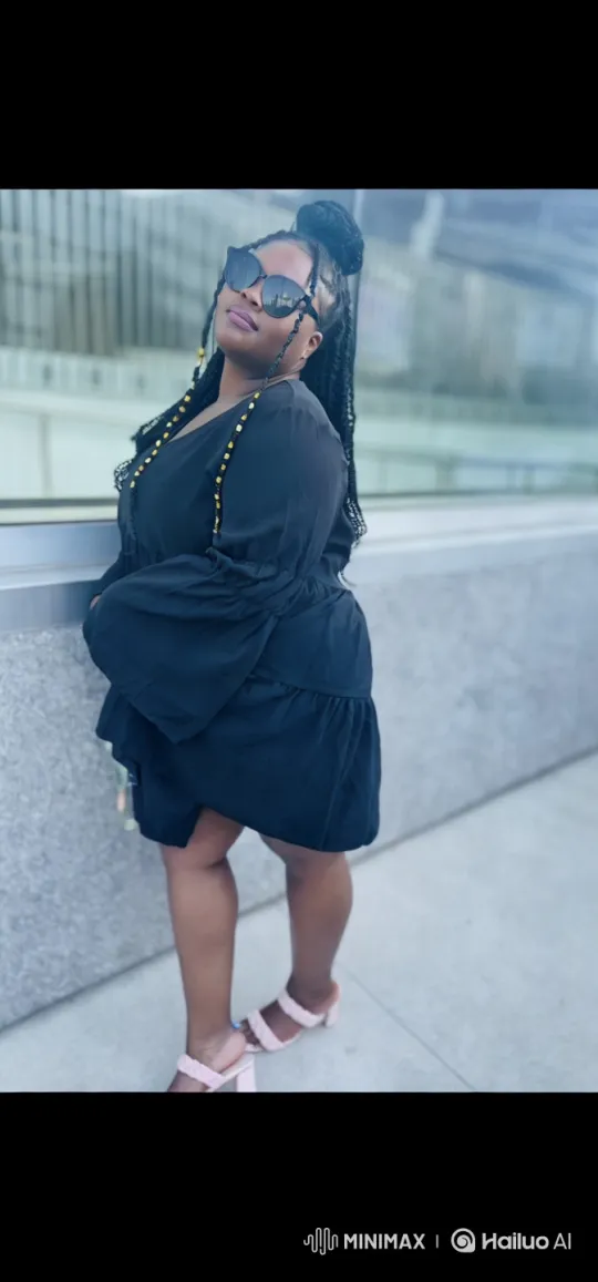 Confident Woman in Black Dress Amidst Modern Architecture – AI Generated Video | Hailuo AI