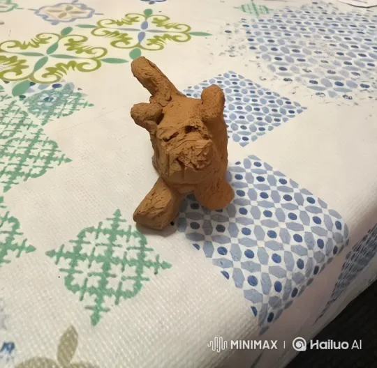 Clay Figure's Journey Across a Patterned Tablecloth – AI Generated Video | Hailuo AI