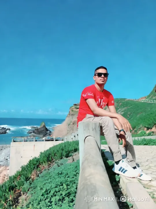 Contemplative Man on Coastal Cliff with Expansive View – AI Generated Video | Hailuo AI