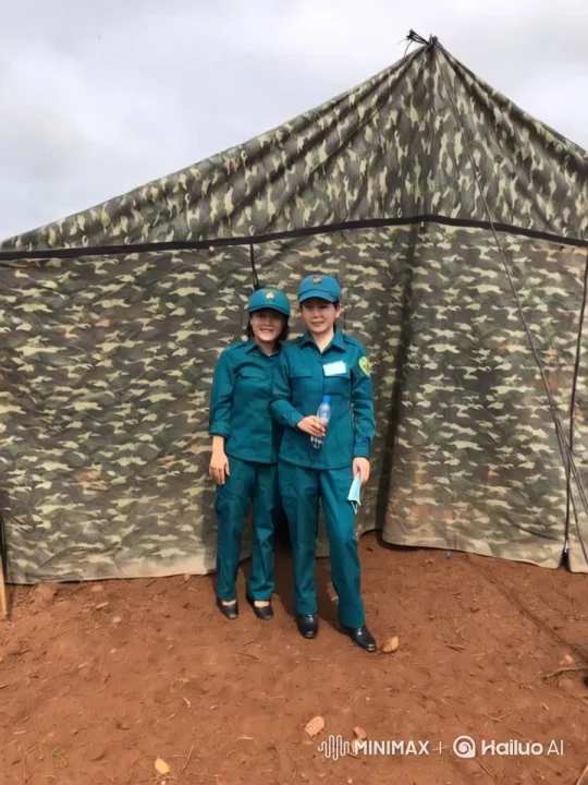 Military Duo in Camouflage Tent Amidst Reddish Soil – AI Generated Video | Hailuo AI
