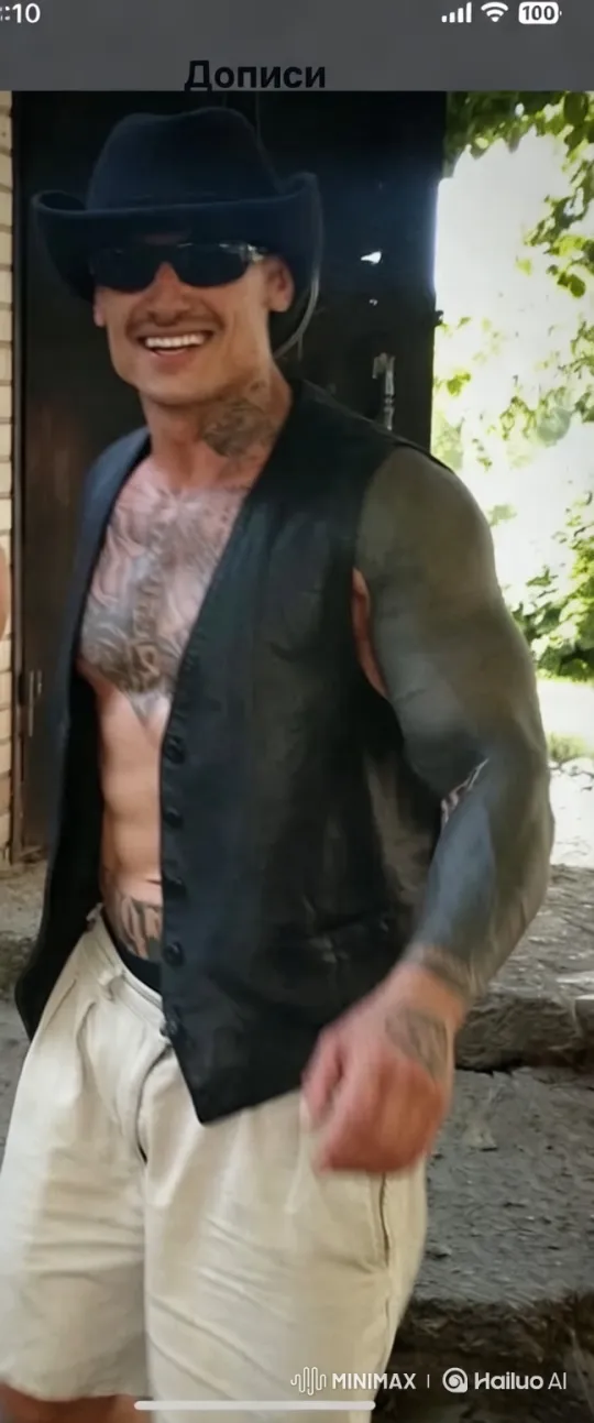Modern Cowboy Showcases Tattoos in Rustic Setting – AI Generated Video | Hailuo AI
