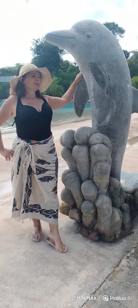 Peaceful Stroll on a Sandy Shore with Dolphin Statue – AI Generated Video | Hailuo AI