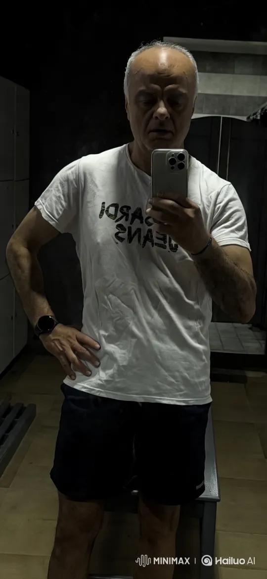Man in White T-Shirt Reflects in Minimalist Room – AI Generated Video | Hailuo AI
