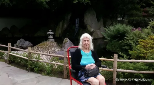 Elderly Woman in Serene Garden with Dynamic Camera Work – AI Generated Video | Hailuo AI